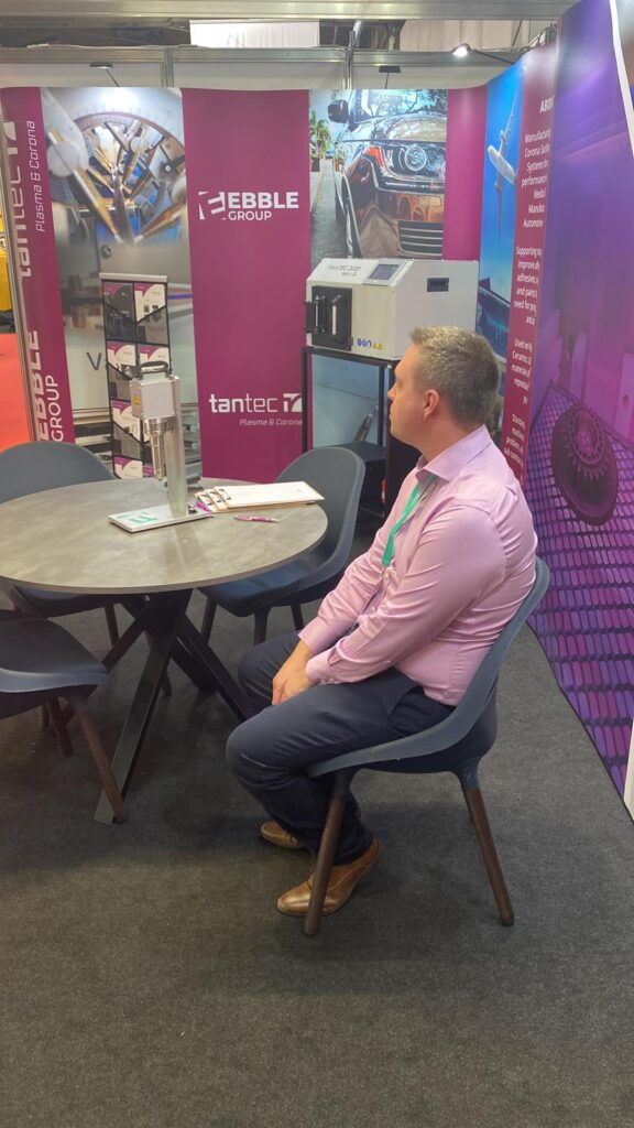 Tired exhibitor sits at a meeting table